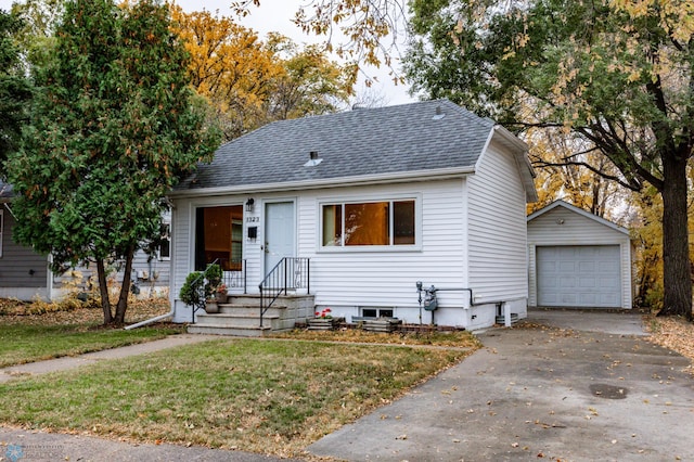 bungalow-style house with an outbuilding, a front lawn, and a garage