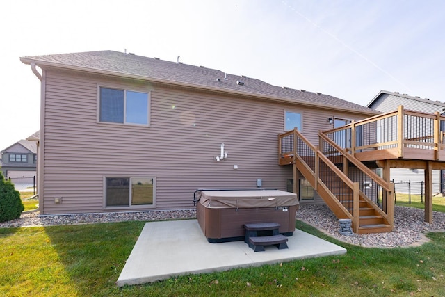 rear view of property featuring a hot tub, a patio area, a wooden deck, and a yard