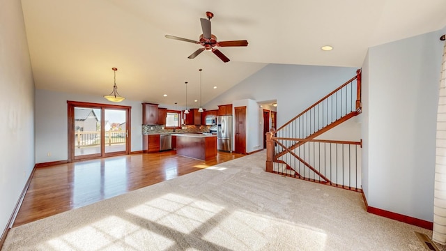 unfurnished living room with lofted ceiling, wood-type flooring, and ceiling fan