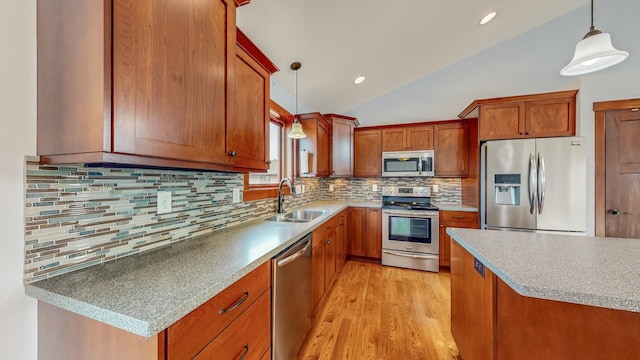 kitchen with tasteful backsplash, sink, hanging light fixtures, stainless steel appliances, and vaulted ceiling