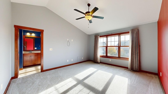 carpeted spare room with vaulted ceiling and ceiling fan