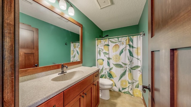 bathroom featuring toilet, a textured ceiling, walk in shower, and vanity