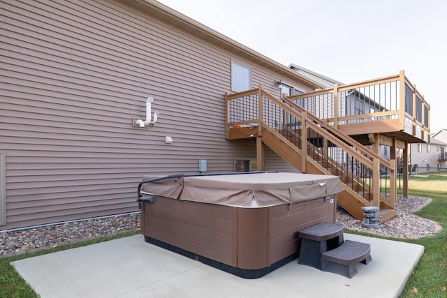 view of patio / terrace with a hot tub and a deck