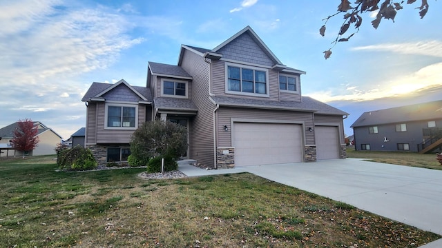 craftsman house featuring a yard and a garage