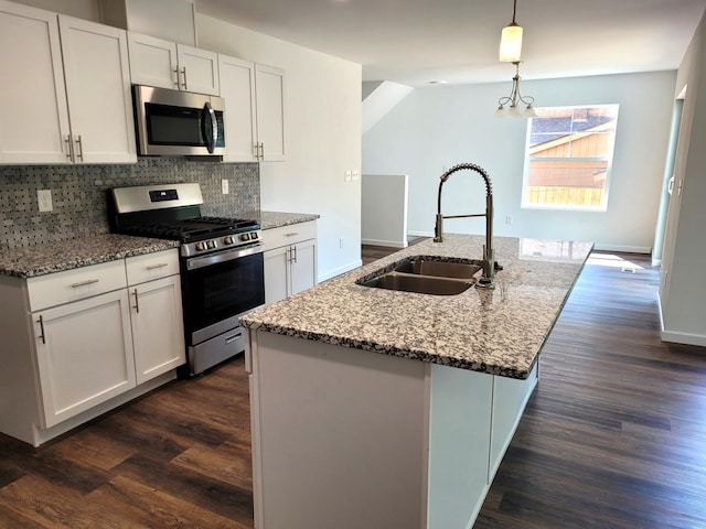 kitchen with dark wood-type flooring, white cabinets, stainless steel appliances, and sink