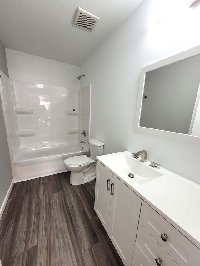 full bathroom featuring vanity, hardwood / wood-style floors, shower / tub combination, and toilet