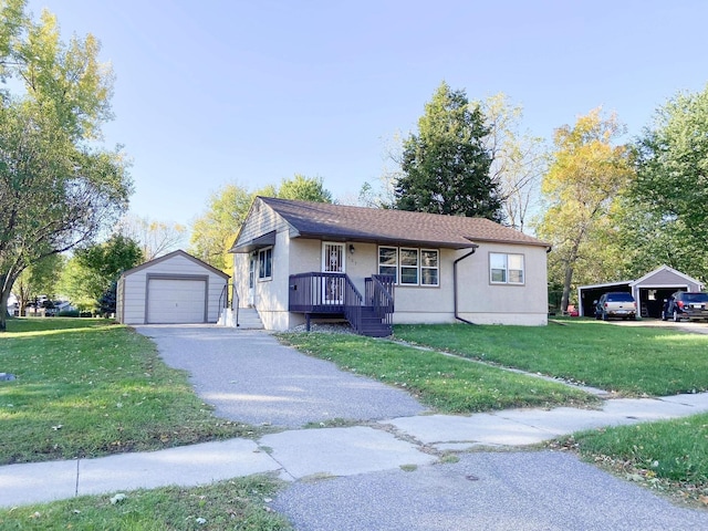 view of front facade featuring an outbuilding, a front yard, and a garage