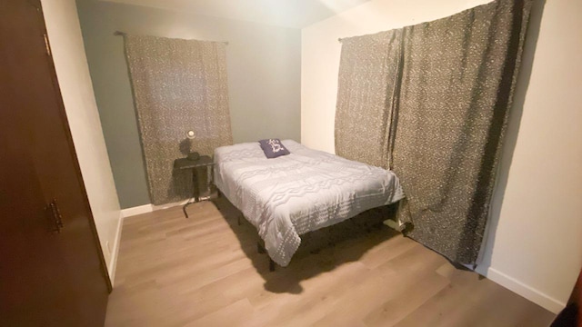 bedroom with hardwood / wood-style flooring