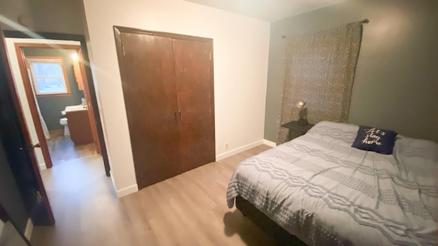 bedroom with a closet and hardwood / wood-style flooring