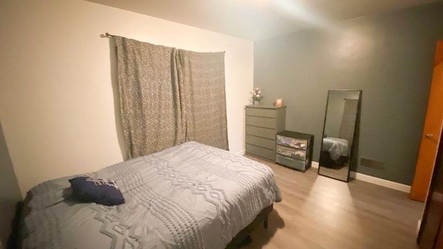 bedroom with light hardwood / wood-style floors