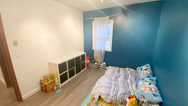 bedroom with light wood-type flooring