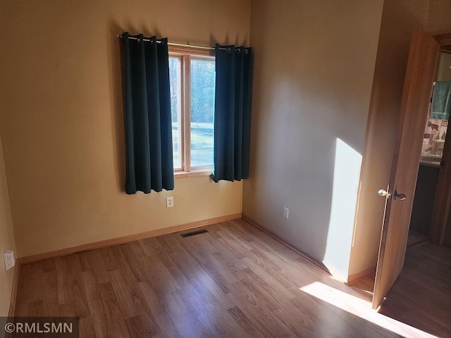 unfurnished room featuring light hardwood / wood-style flooring