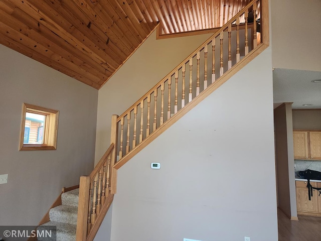 staircase with vaulted ceiling and wooden ceiling