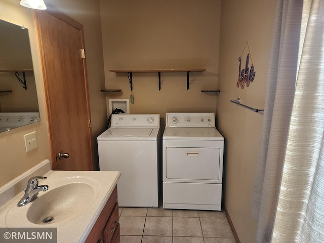 washroom featuring sink, separate washer and dryer, and light tile patterned floors