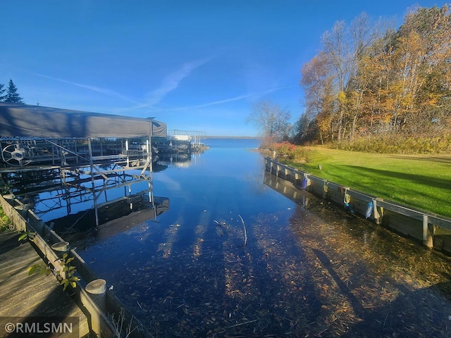 view of dock featuring a water view and a lawn