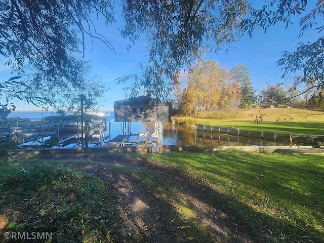 view of yard featuring a water view, a boat dock, and a rural view