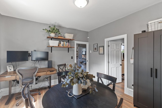 dining space featuring light wood-type flooring