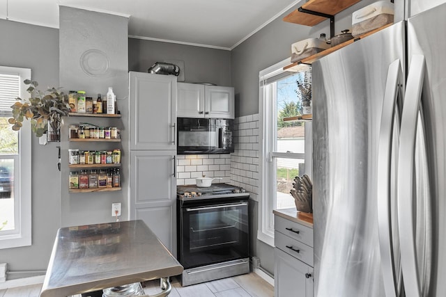 kitchen with ornamental molding, black appliances, white cabinets, and decorative backsplash