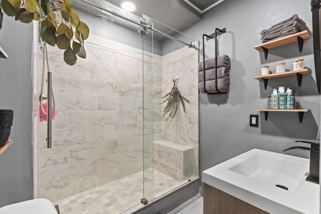 bathroom with vanity, a shower with shower door, and toilet