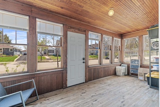 sunroom / solarium with wood ceiling and a healthy amount of sunlight