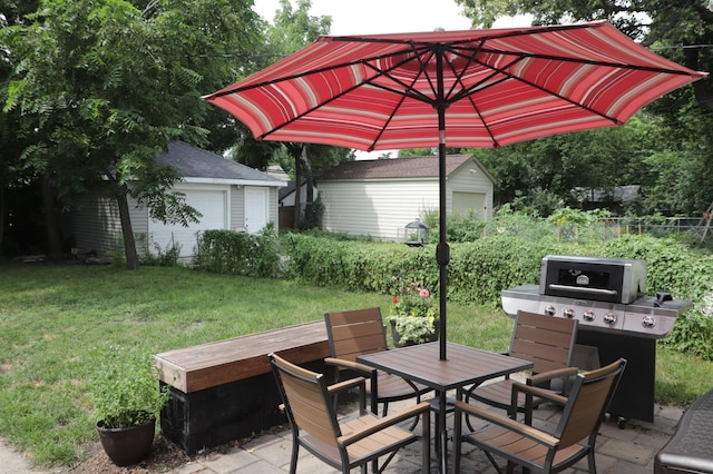 view of patio / terrace with area for grilling, an outbuilding, and a garage