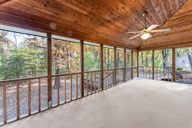 unfurnished sunroom with wood ceiling, ceiling fan, and vaulted ceiling