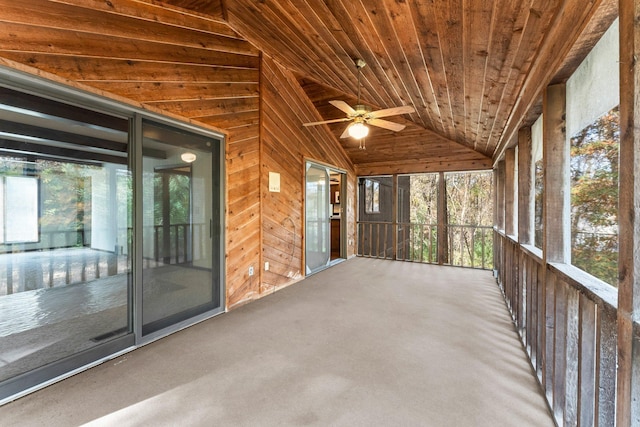 unfurnished sunroom with ceiling fan, lofted ceiling, and wood ceiling