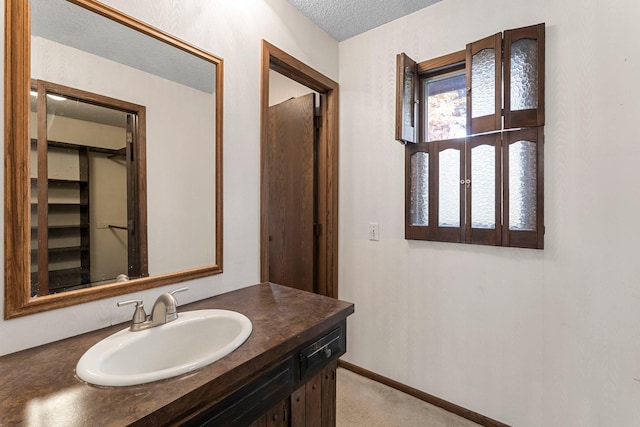 bathroom with vanity and a textured ceiling