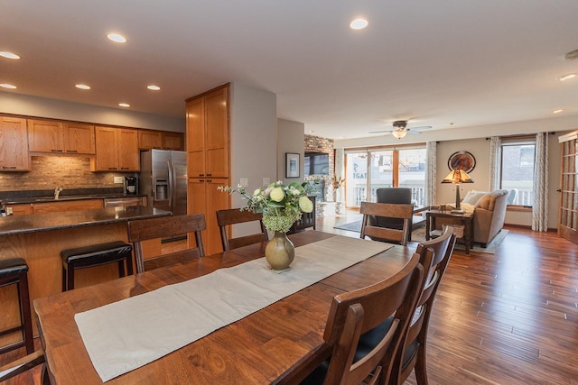 dining area with dark wood-type flooring and ceiling fan