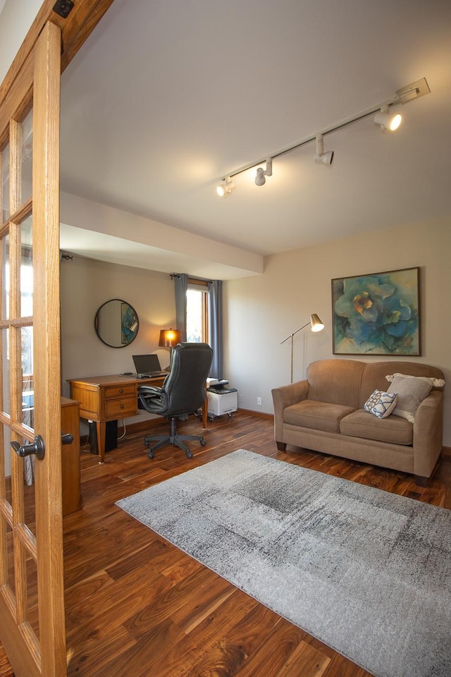 living room featuring track lighting and dark hardwood / wood-style floors