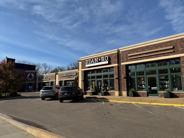 view of building exterior with uncovered parking