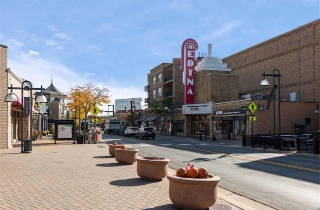 view of road featuring street lighting, curbs, and sidewalks