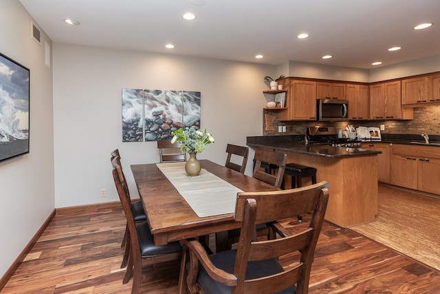 dining space with recessed lighting, visible vents, baseboards, and wood finished floors