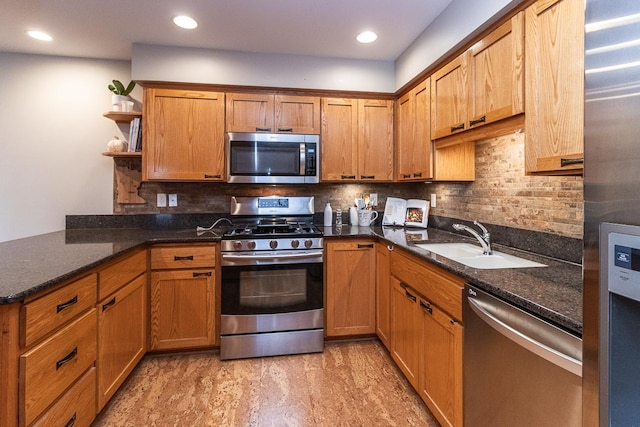 kitchen with tasteful backsplash, a peninsula, stainless steel appliances, open shelves, and a sink