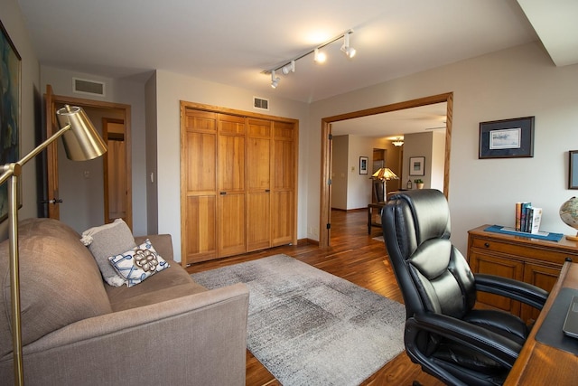 office space featuring visible vents and wood finished floors