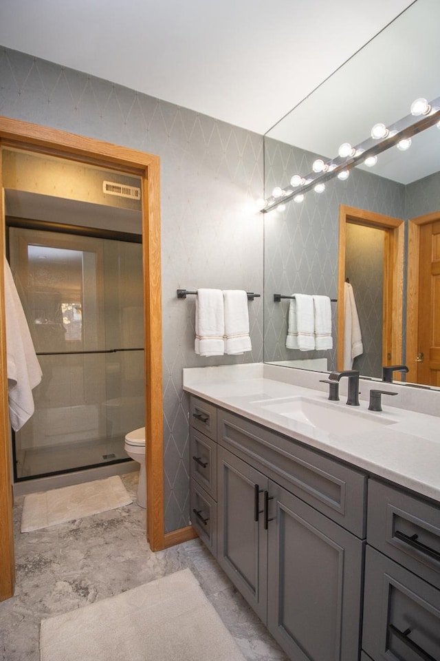 full bathroom with a shower stall, toilet, tile walls, and vanity