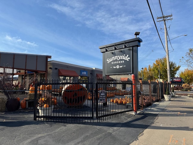 view of community with fence and a gate