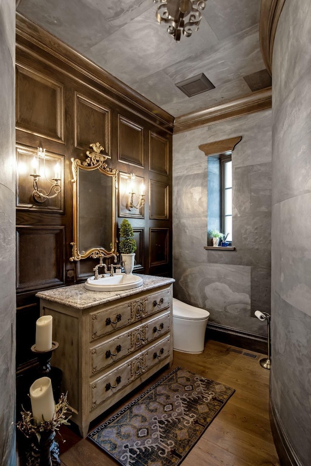 10675 Cavallo Rdg, Eden Prairie, MN 55347 - half bathroom featuring vanity, wood finished floors, and ornamental molding