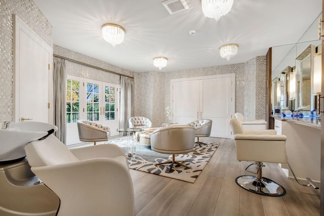 10675 Cavallo Rdg, Eden Prairie, MN 55347 - living area featuring wallpapered walls, wood finished floors, and a chandelier