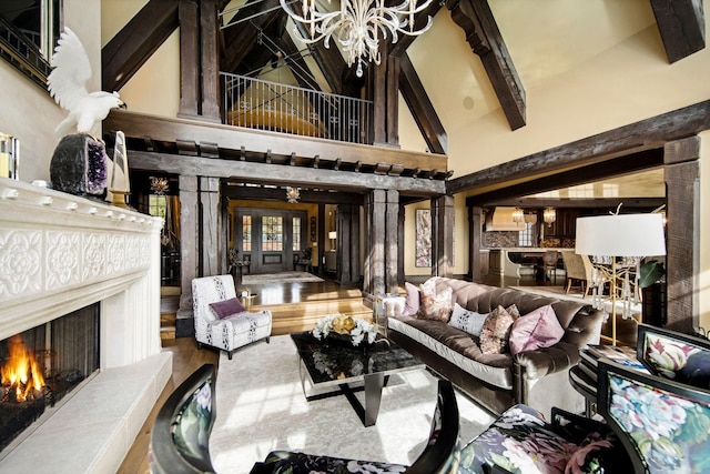 10675 Cavallo Rdg, Eden Prairie, MN 55347 - living room featuring a chandelier, high vaulted ceiling, a warm lit fireplace, beamed ceiling, and wood finished floors