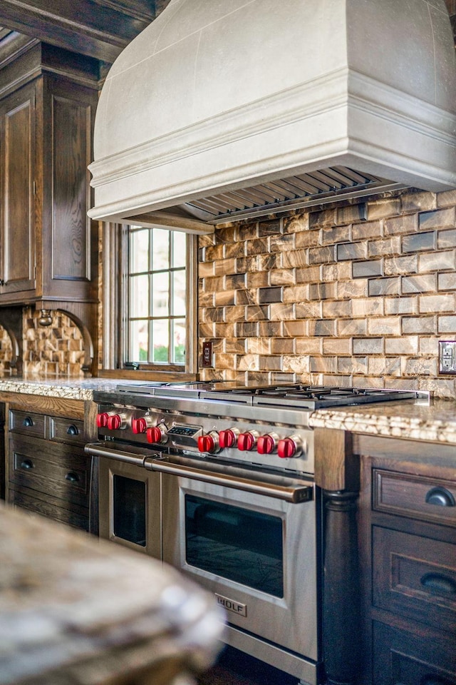 10675 Cavallo Rdg, Eden Prairie, MN 55347 - kitchen with range with two ovens, custom range hood, decorative backsplash, and dark brown cabinetry