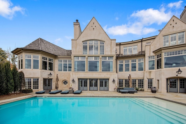 10675 Cavallo Rdg, Eden Prairie, MN 55347 - back of property featuring an outdoor pool, french doors, stucco siding, and a patio