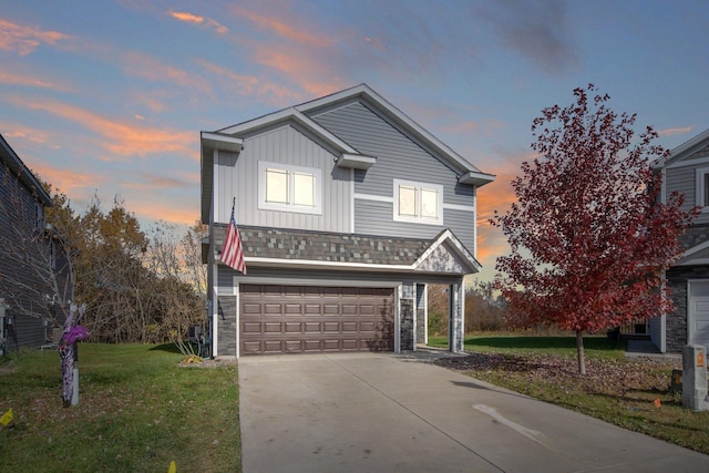 view of property featuring a yard and a garage