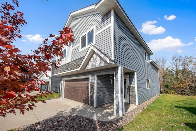 view of property exterior featuring a garage and a lawn