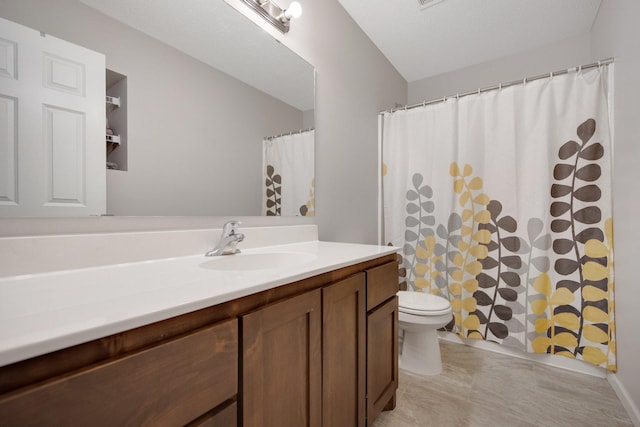 bathroom featuring vanity, toilet, a textured ceiling, and a shower with shower curtain