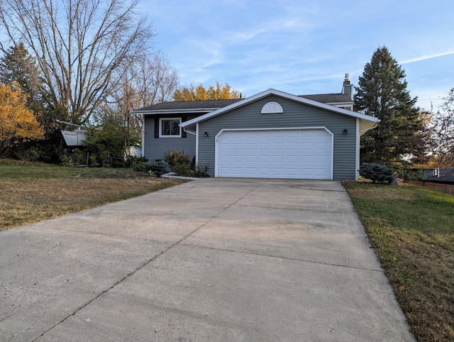 view of front facade with a garage and a front lawn