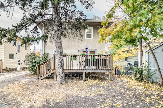 rear view of property with a wooden deck