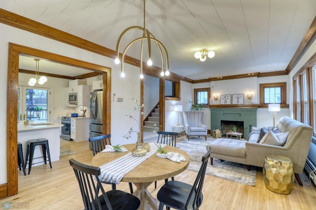 dining area featuring light hardwood / wood-style floors, a healthy amount of sunlight, and sink