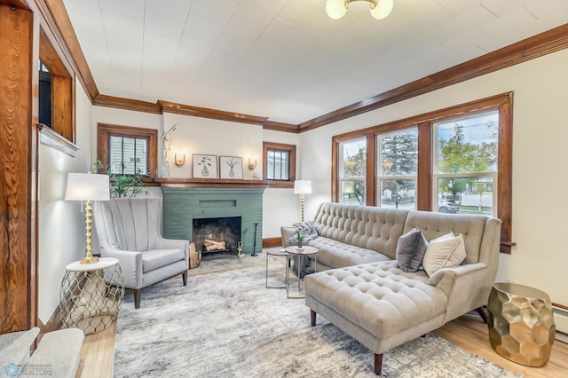 living room with crown molding, a brick fireplace, and hardwood / wood-style flooring