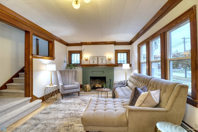 living room featuring wood-type flooring, ornamental molding, and a brick fireplace